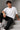 Model wearing white POPCASE Lando Norris McLaren oversized t shirt with orange speed mark logo on left chest