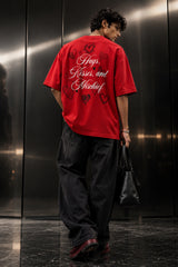 Red oversized tshirt with Hugs Kisses and Mischief white cursive script and hand-drawn hearts back print, boxy fit, men India