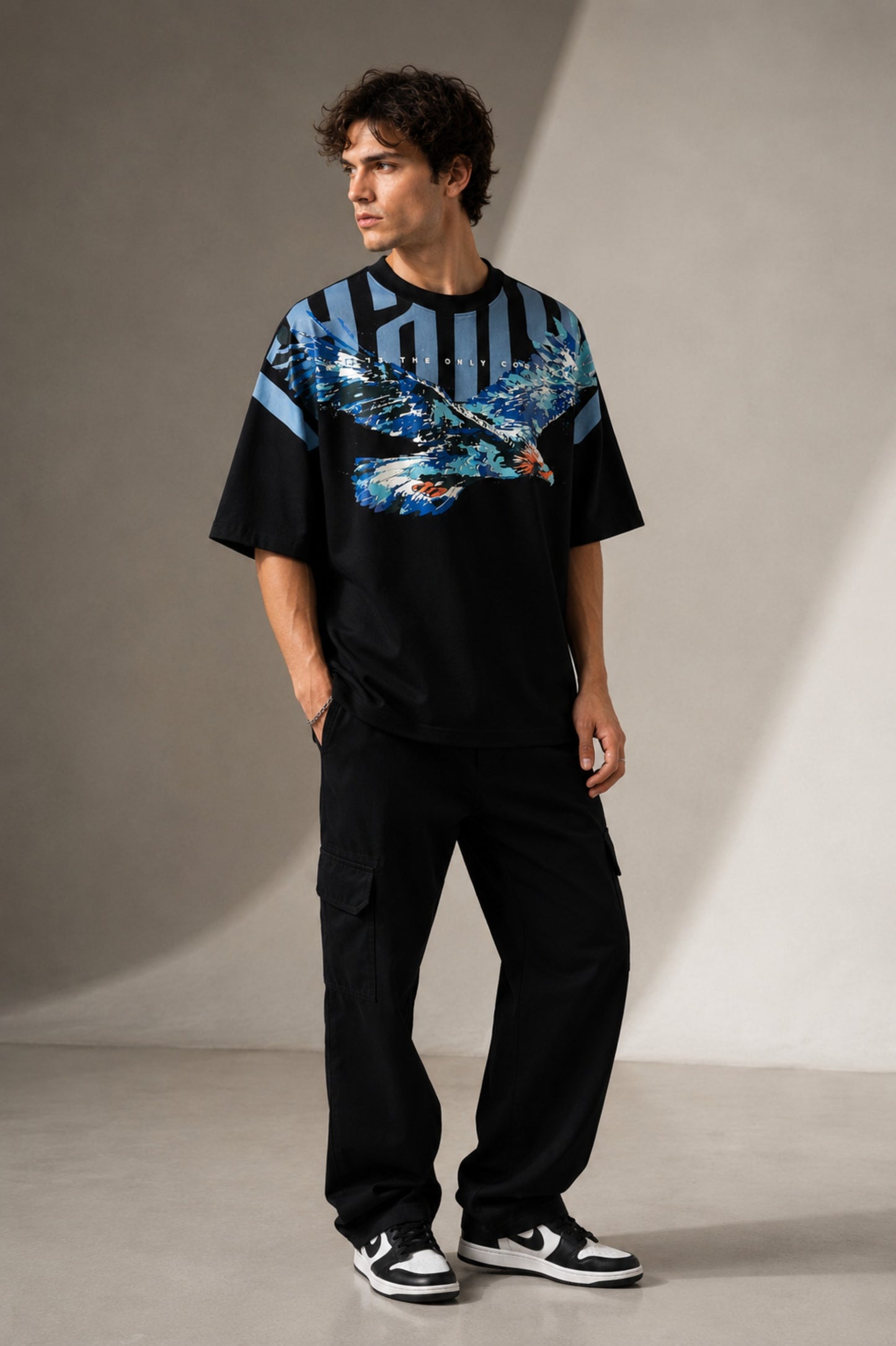 LAYERS black oversized t-shirt with a dynamic blue, white, and orange abstract graphic print, featuring "THE ONLY C" text detail, showcasing its premium fabric and streetwear aesthetic.