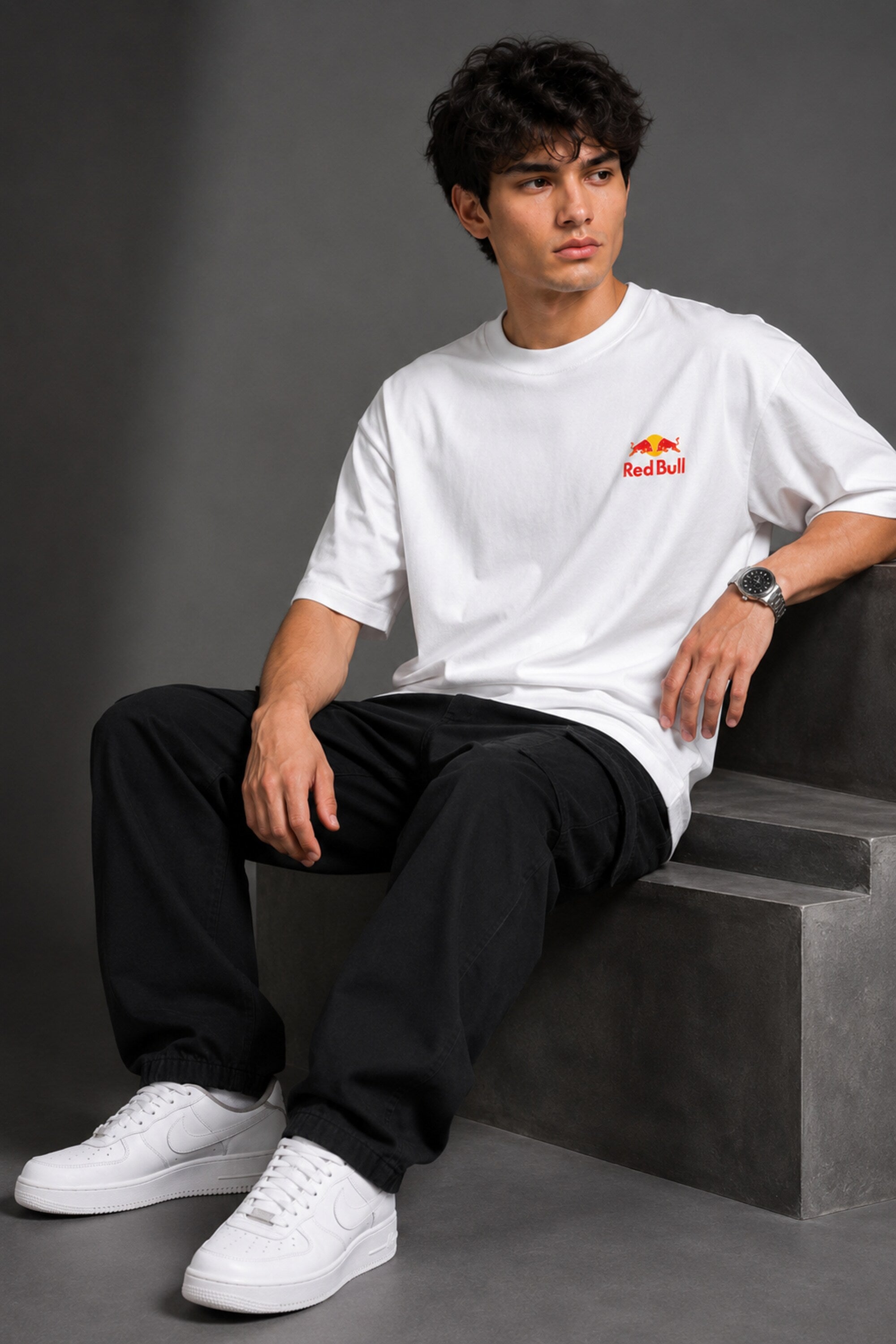 Model wearing white POPCASE Max Verstappen Red Bull oversized t shirt with Red Bull chest logo and large REDBULL race car back graphic