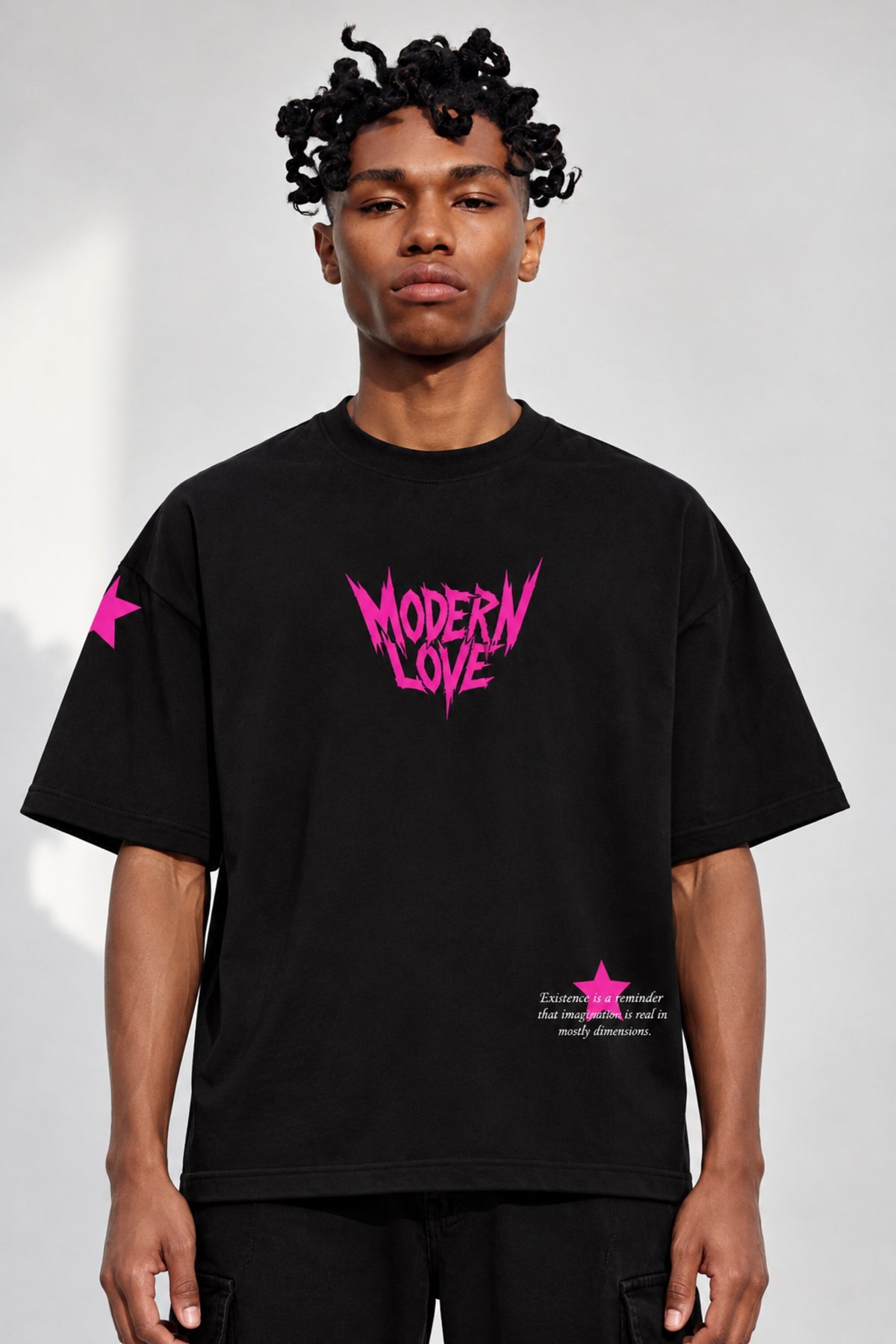Black oversized tshirt with Modern Love electric pink metal rock font on chest and pink star on sleeve, drop shoulder boxy fit, men India