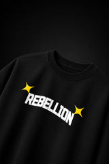 Rebellion black oversized t-shirt with bold white text and gold sparkle star graphic