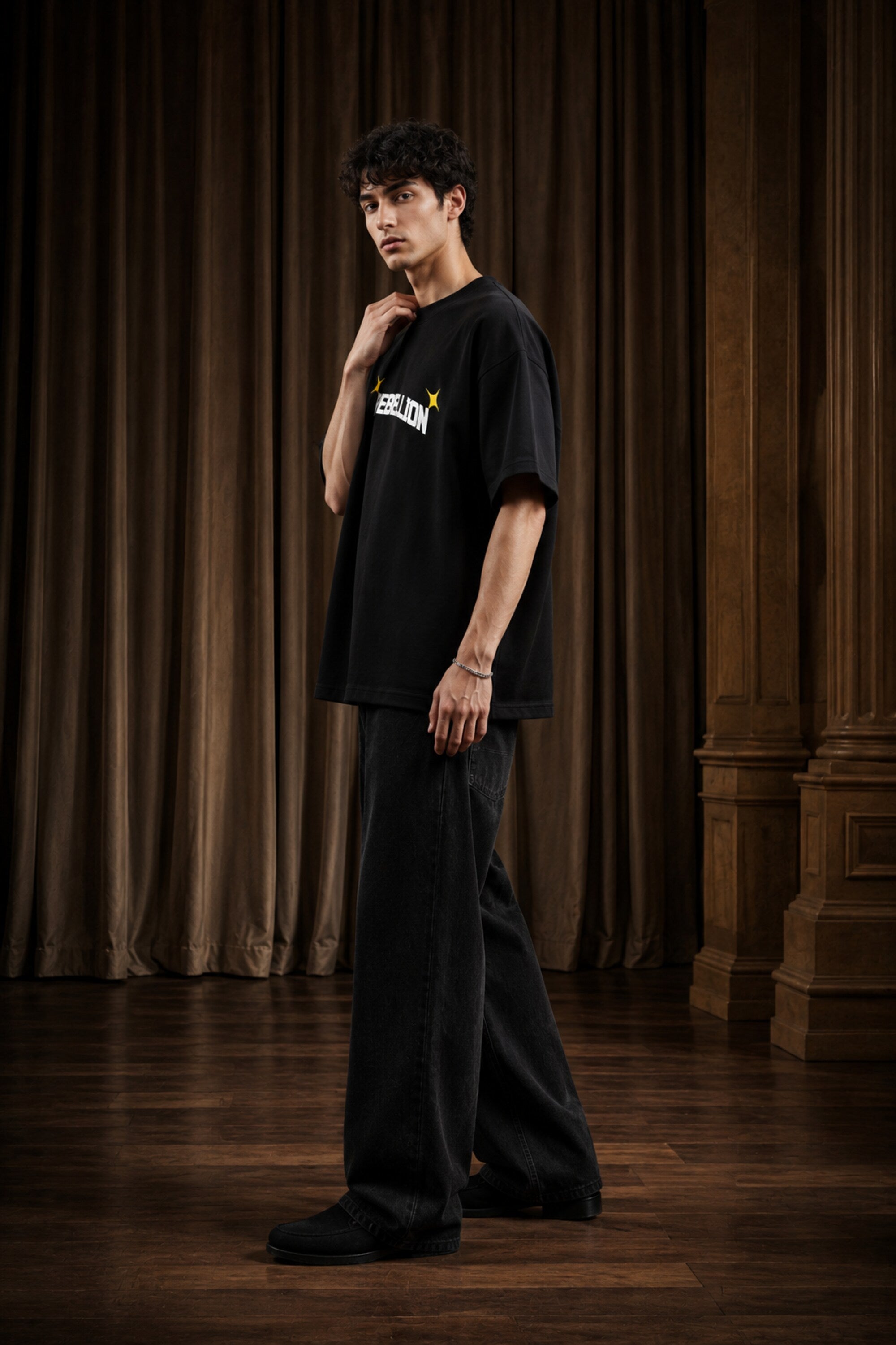 Rebellion black oversized t-shirt with bold white text and gold sparkle star graphic