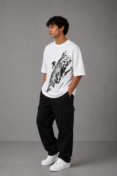 POP-MOUNTAIN-CLIMBER oversized t-shirt in white, featuring a striking black and white graphic of a mountain climber. Designed for ultimate comfort and streetwear style.