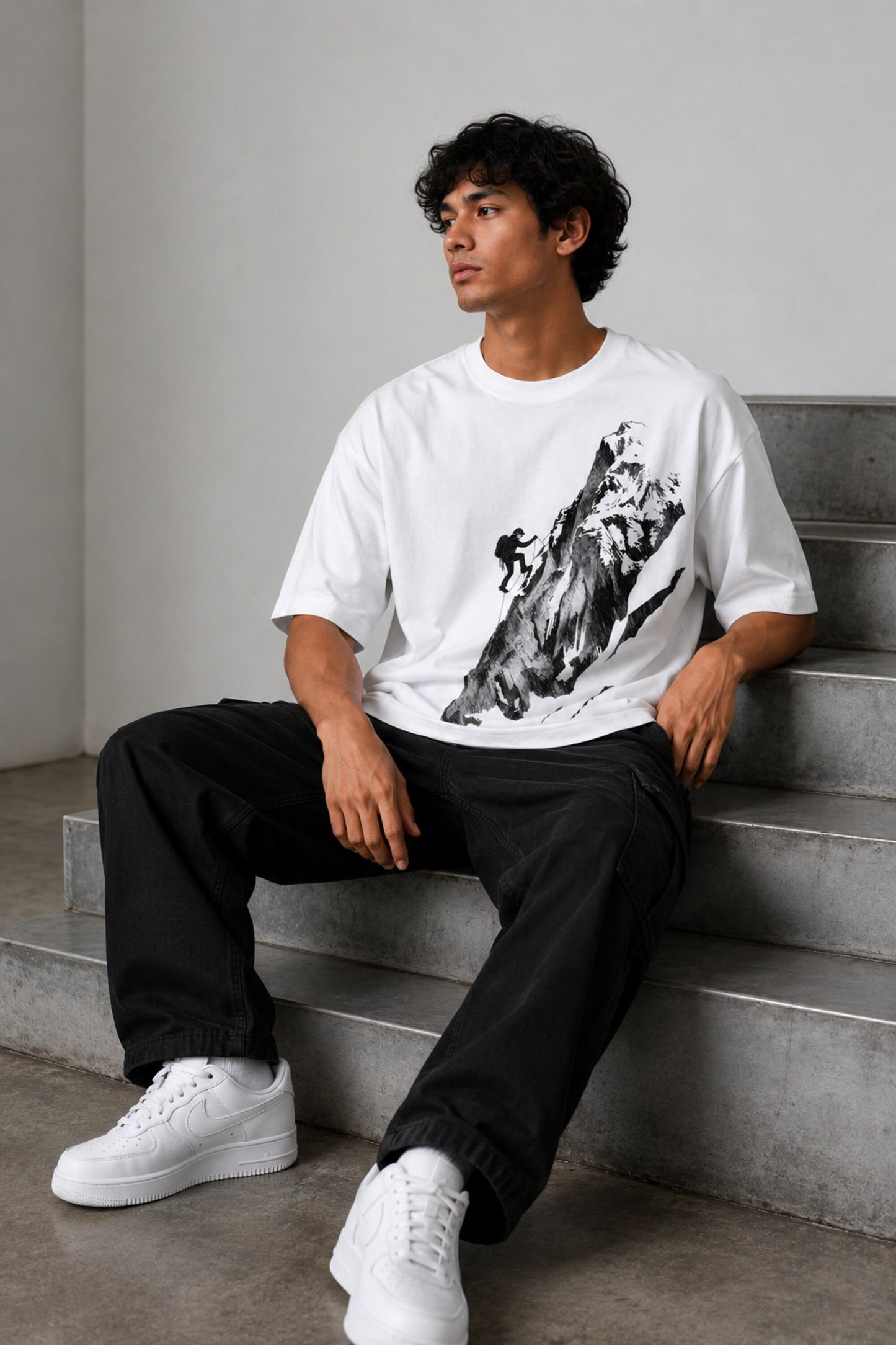 POP-MOUNTAIN-CLIMBER oversized t-shirt in white, featuring a striking black and white graphic of a mountain climber. Designed for ultimate comfort and streetwear style.