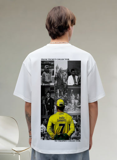 Person wearing a white t-shirt with a graphic on the back, sitting on a chair.