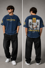Model wearing an anthracite black Mbappe oversized t-shirt with gold "MBAPPE" graphic and signature, Real Madrid and number 7 logos on sleeves. - midnight indigo