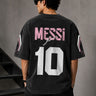 Man wearing an anthracite black Messi oversized t-shirt with a circular team logo and signature, showcasing the relaxed fit and premium fabric. - anthracite black