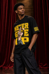 Black tshirt with Never Give Up yellow varsity block letters and John Cena graphic on front, drop shoulder boxy fit, men India