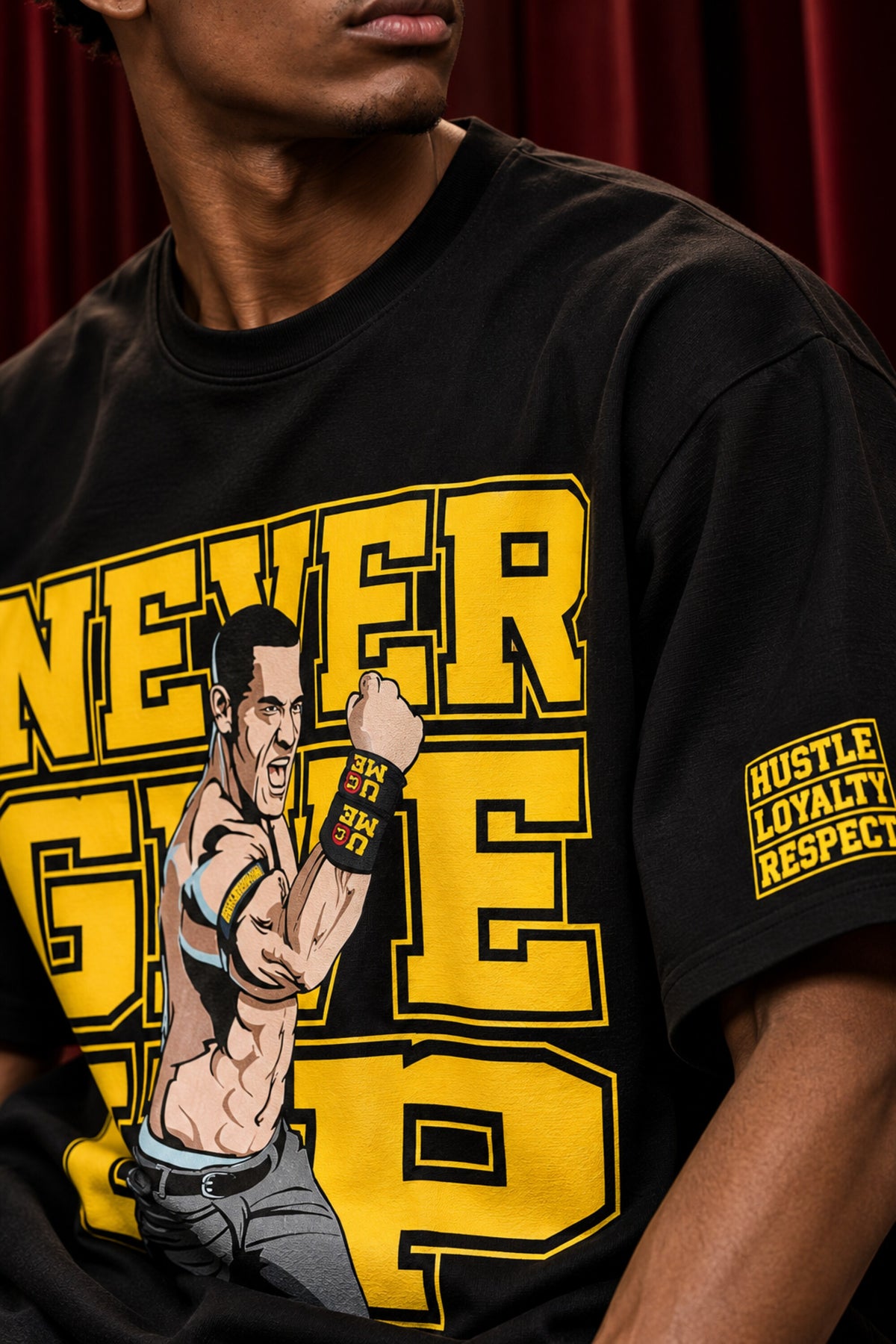 Black tshirt with Never Give Up yellow varsity block letters and John Cena graphic on front, drop shoulder boxy fit, men India