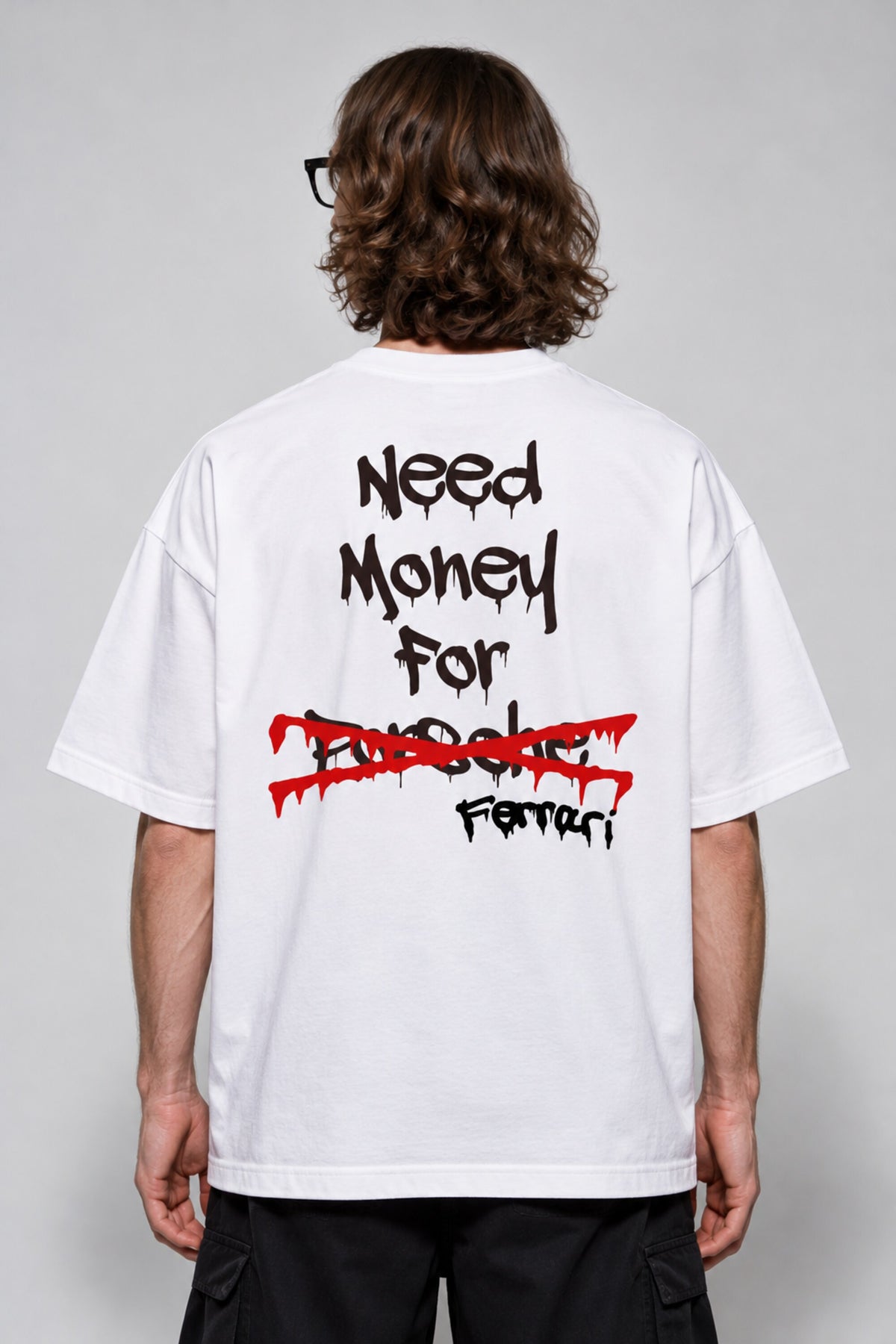White oversized tshirt with Need Money for Ferrari bold drip graffiti text on back in black and red, drop shoulder boxy fit, men India