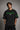 Model wearing an oversized black Neymar Legacy t-shirt with green 'Neymar' graphic and Brazilian CBF crest on sleeve.