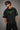 Model wearing an oversized black Neymar Legacy t-shirt with green 'Neymar' graphic and Brazilian CBF crest on sleeve.
