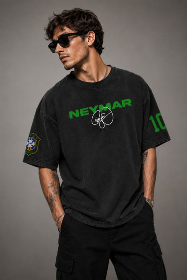 Model wearing an oversized black Neymar Legacy t-shirt with green 'Neymar' graphic and Brazilian CBF crest on sleeve.