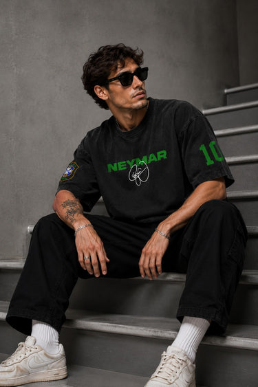 Model wearing an oversized black Neymar Legacy t-shirt with green 'Neymar' graphic and Brazilian CBF crest on sleeve.