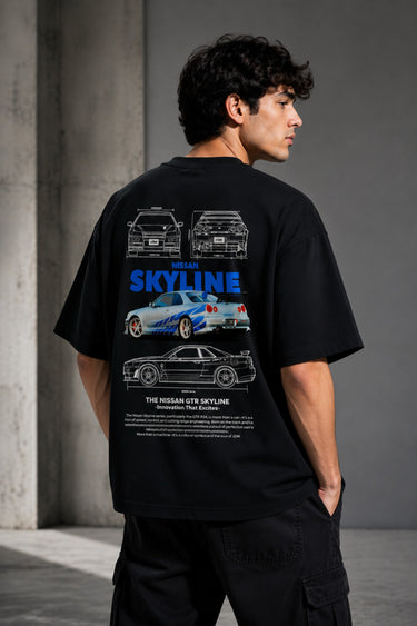 Black oversized t-shirt featuring a detailed white blueprint and a silver Nissan Skyline R34 with blue racing stripes graphic. Includes text 'The Nissan Skyline GTR'.