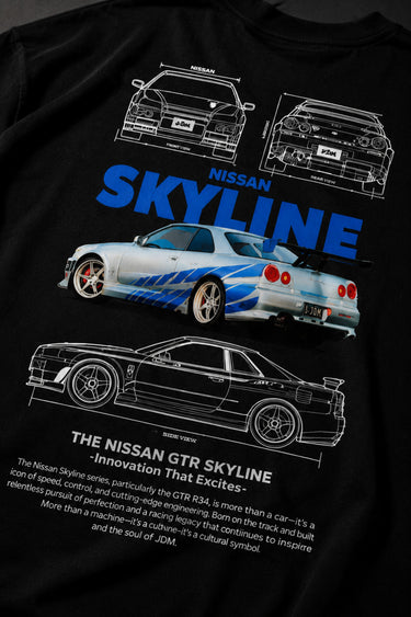 Black oversized t-shirt featuring a detailed white blueprint and a silver Nissan Skyline R34 with blue racing stripes graphic. Includes text 'The Nissan Skyline GTR'.