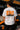 Model wearing white POPCASE Oscar Piastri McLaren oversized t shirt with orange McLaren speed mark logo and McLaren race car back graphic