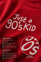 Model wearing a red oversized t-shirt with 'Just a 90's Kid' graphic. The tee has a relaxed fit, paired with black jeans and white sneakers, embodying a retro streetwear style.