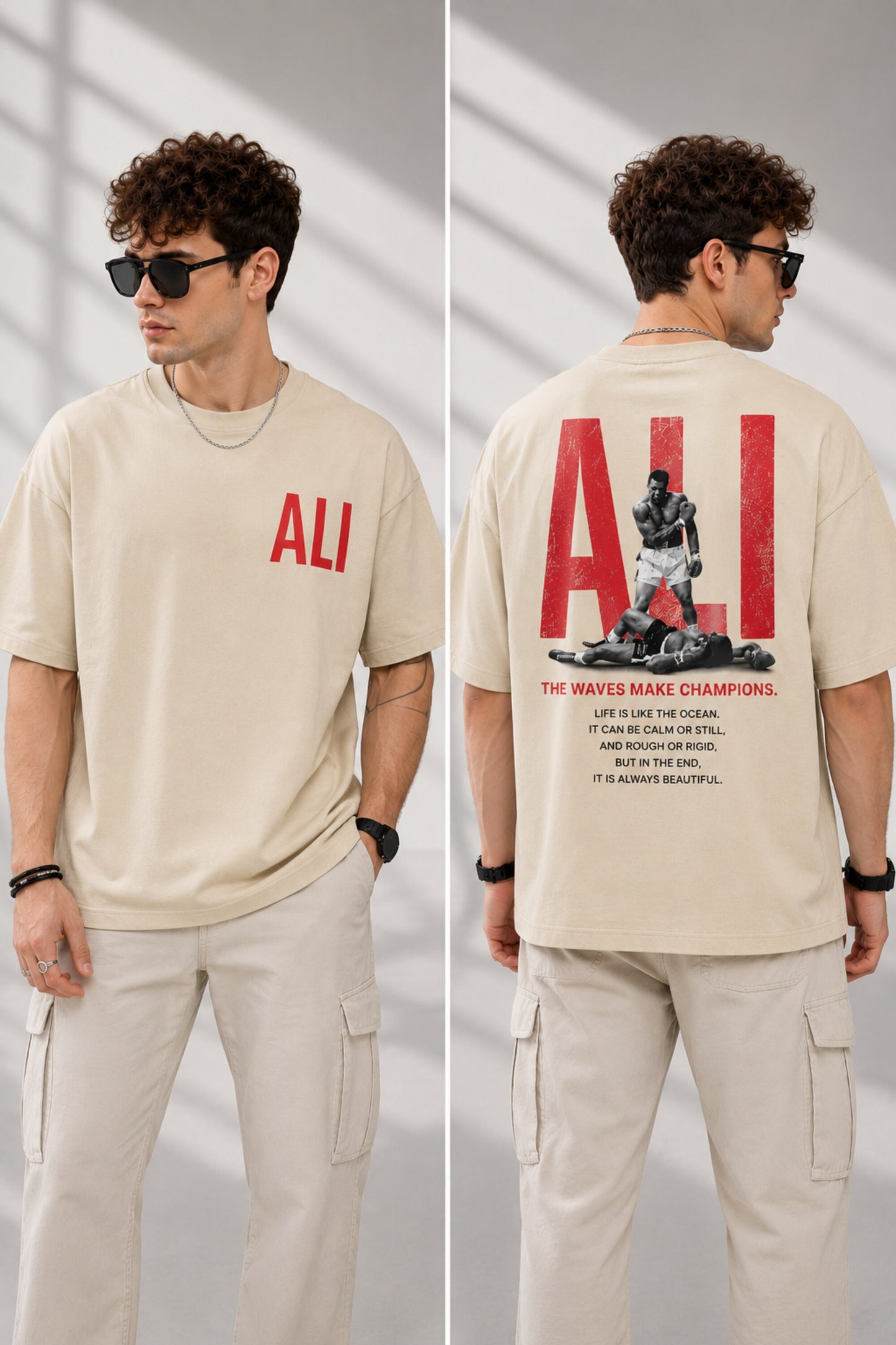 Man wearing a white ALI oversized t-shirt and beige cargo pants, sitting on grey stairs. He wears black sunglasses and jewelry. - beige