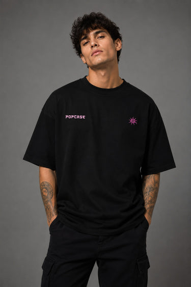 Black POPCASE oversized tshirt with Bad Intentions Only pink gothic text and tribal sun print on back, worn with black cargo pants