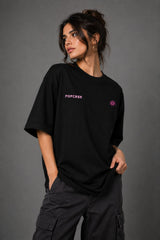 Black POPCASE oversized tshirt with Bad Intentions Only pink gothic text and tribal sun print on back, worn with black cargo pants