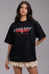 Black POPCASE oversized unisex tshirt with Conquer Yourself in layered red gothic and grey shadow text on front, styled with beige bubble shorts