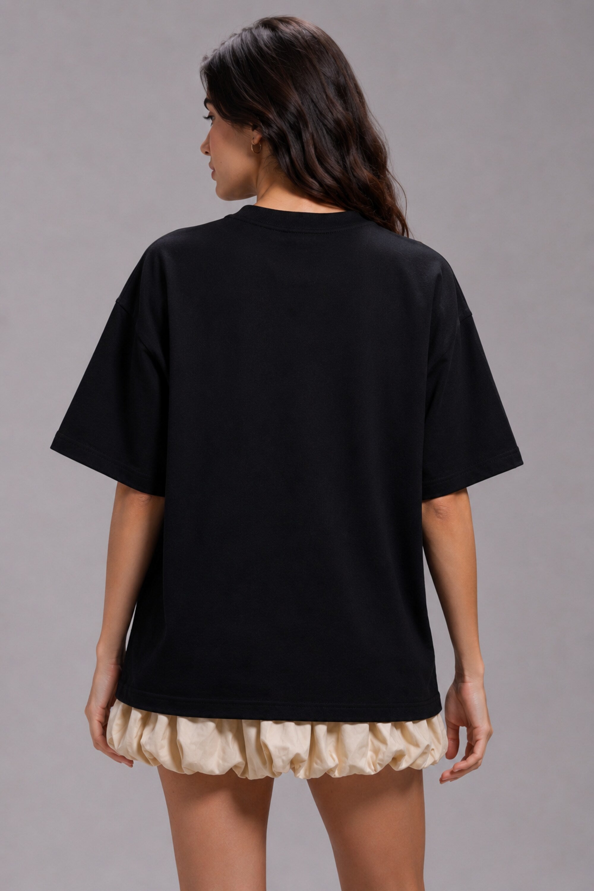 Black POPCASE oversized unisex tshirt with Conquer Yourself in layered red gothic and grey shadow text on front, styled with beige bubble shorts