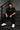 Man wearing a black DISCIPLINE WILD WOLF oversized t-shirt with white 'DISCIPLINE' text, dark wash jeans, and white sneakers, sitting on stairs.