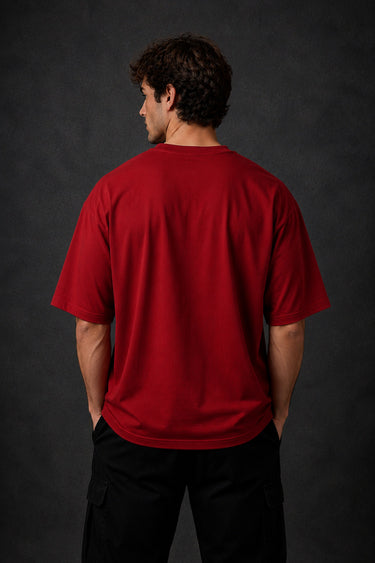 Red Nordic Heritage oversized t-shirt with black Viking-inspired graphic print on the front and back. Close-up shows DTF print quality and fabric texture.