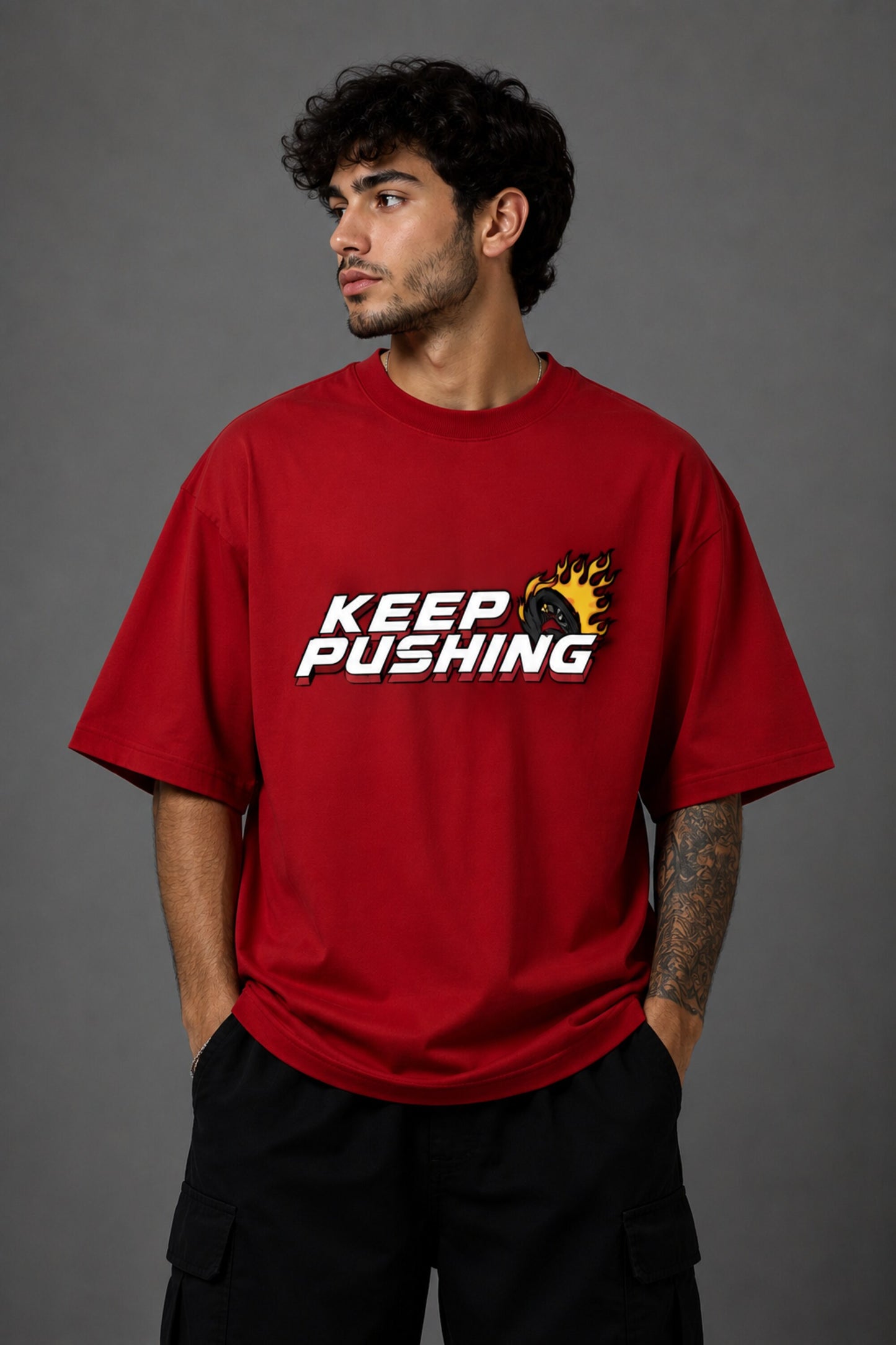 Red POPCASE oversized tshirt with Keep Pushing flaming F1 tire on front and Formula One is my love language vintage McLaren race car graphic on back