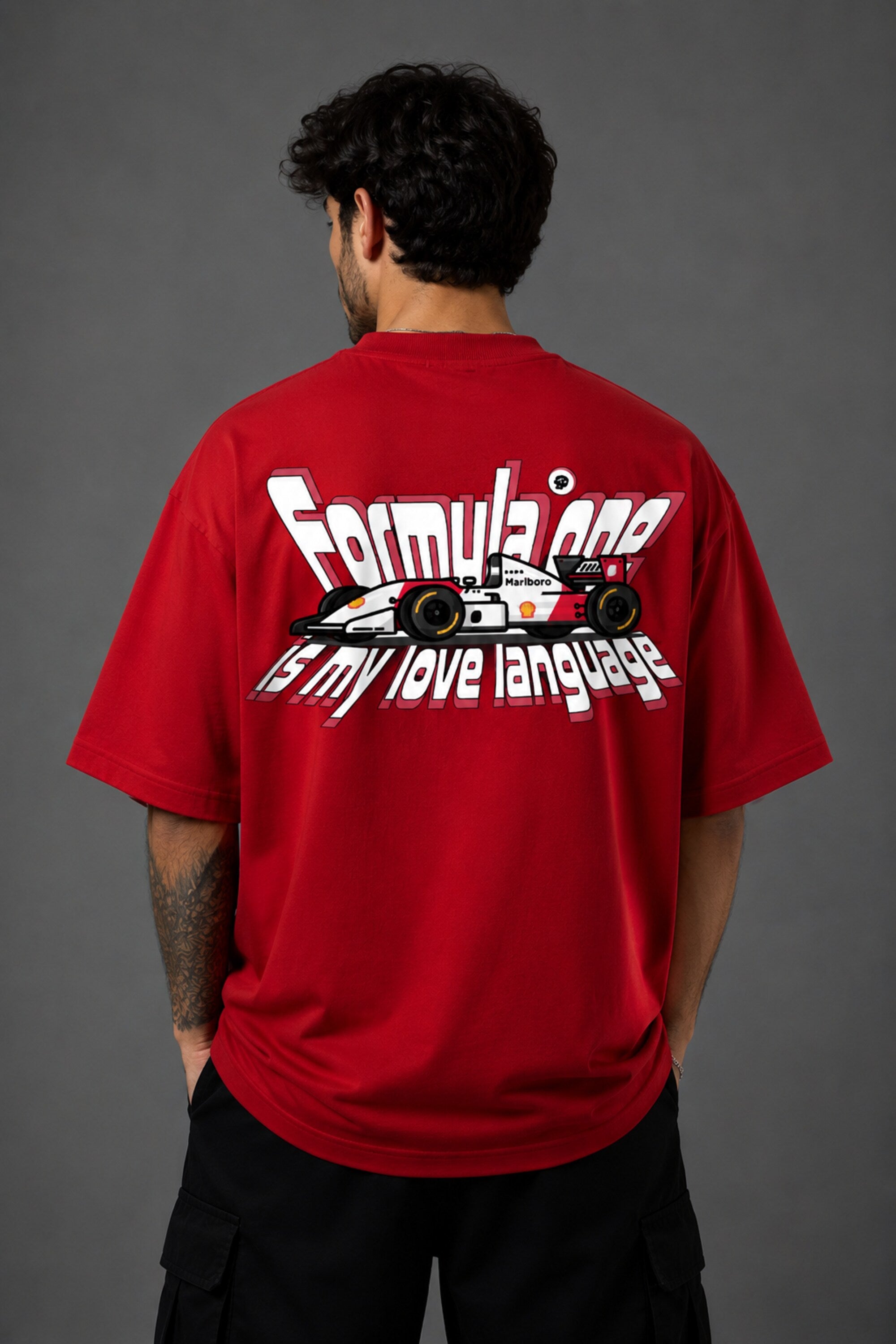 Red POPCASE oversized tshirt with Keep Pushing flaming F1 tire on front and Formula One is my love language vintage McLaren race car graphic on back