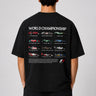 Model wearing a black oversized t-shirt with a small, embroidered Formula 1® logo in white, red, and gray on the chest. Casual streetwear style. - black