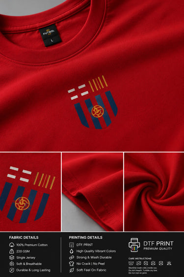 Man wearing a red FCB Messi fan oversized t-shirt, black pants, and white sneakers, sitting on a brown couch.