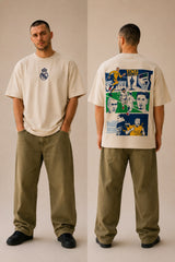 Man wearing a white oversized Real Madrid t-shirt with a circular club crest logo, paired with olive green pants and black sneakers, posing casually with hands in pockets. - beige