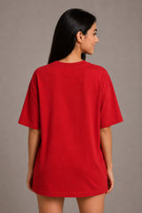 Woman wearing a red t-shirt against a plain background