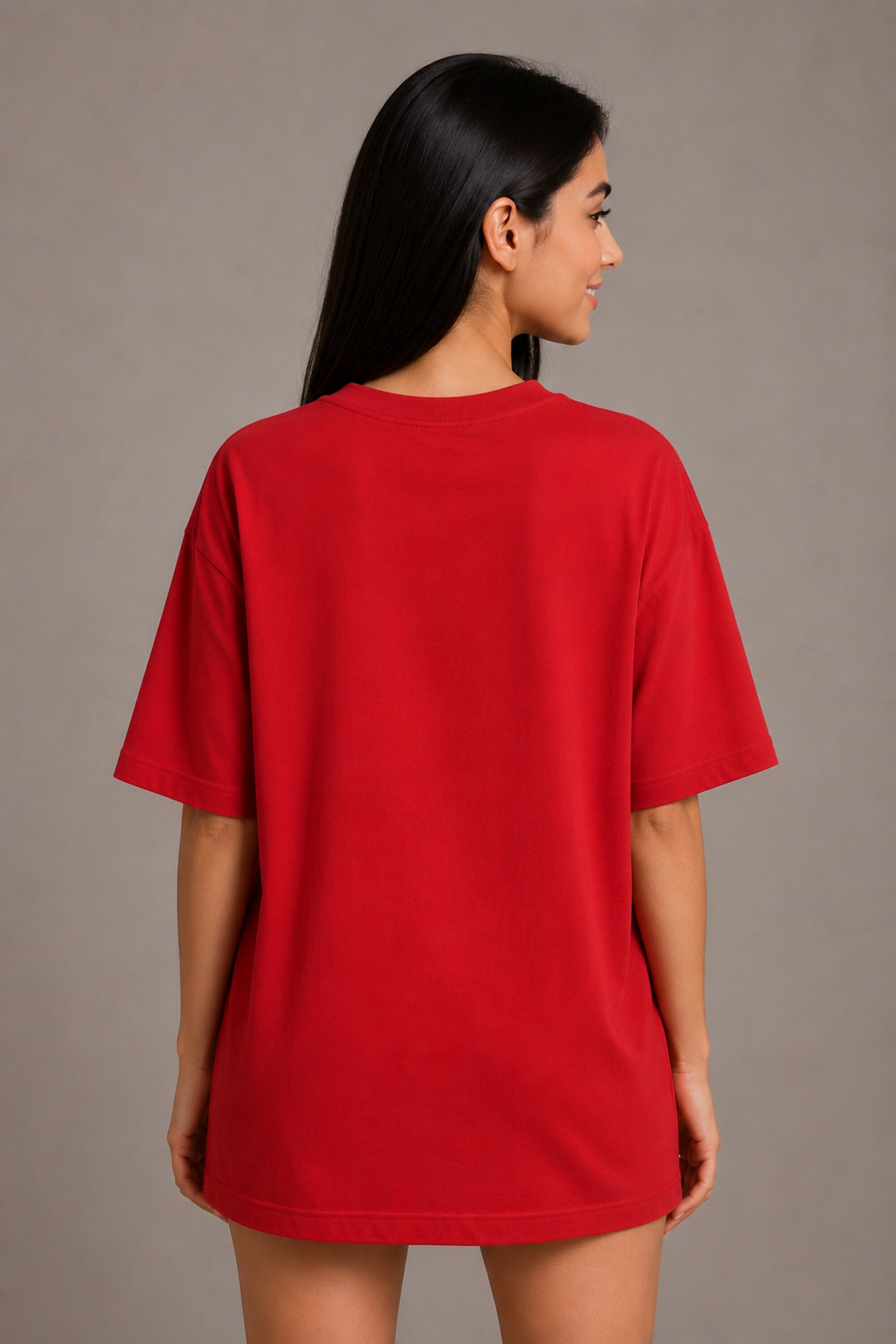 Woman wearing a red t-shirt against a plain background