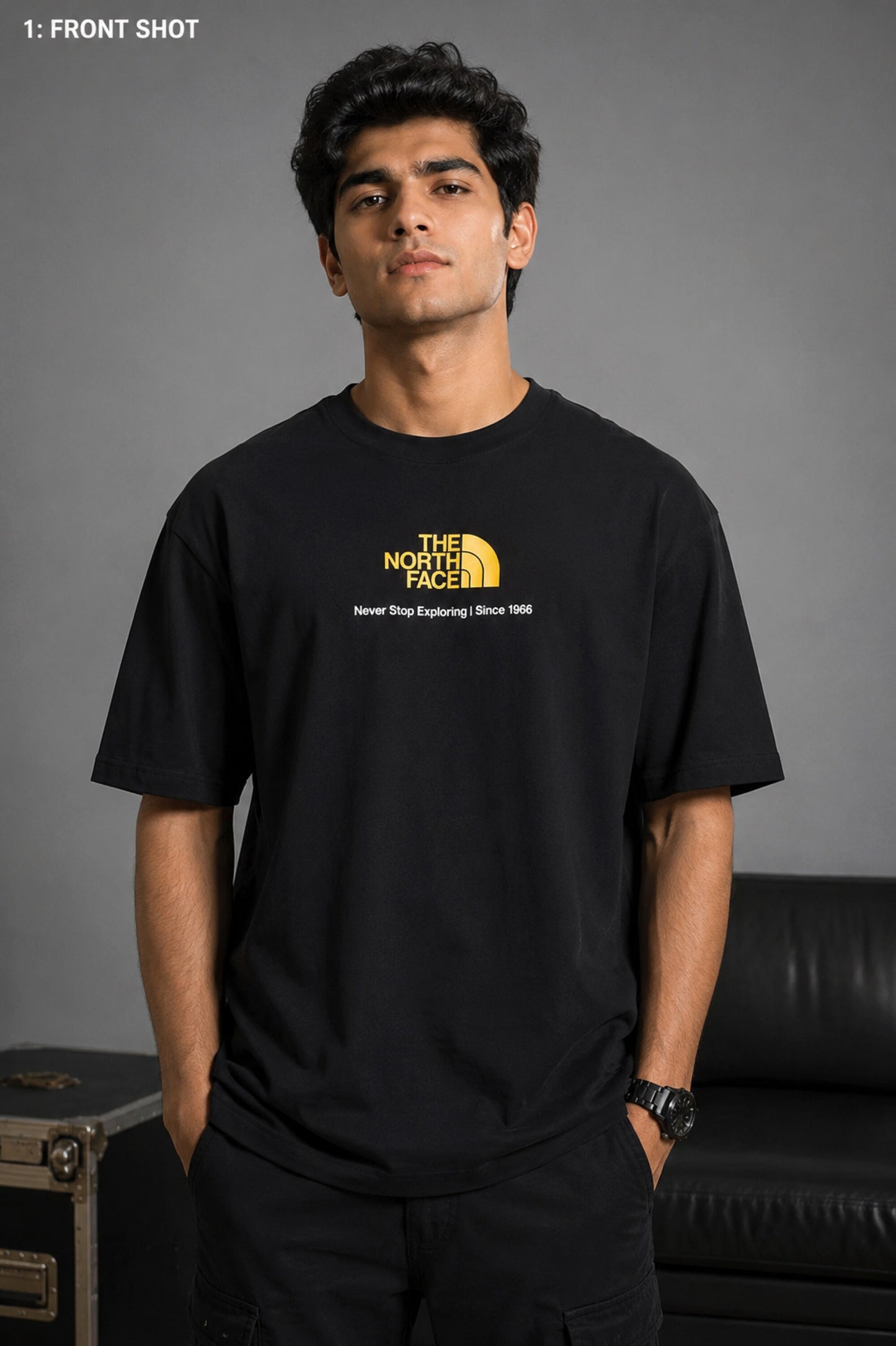 Man wearing FROM THE NORTH oversized t-shirt in beige with black cargo pants and white sneakers. Features The North Face logo and graphic on front and back.
