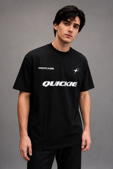 Black QUICKE oversized t-shirt featuring bold white graphic print on the chest and back. Showcasing premium fabric details and relaxed fit.
