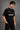 Black QUICKE oversized t-shirt featuring bold white graphic print on the chest and back. Showcasing premium fabric details and relaxed fit.