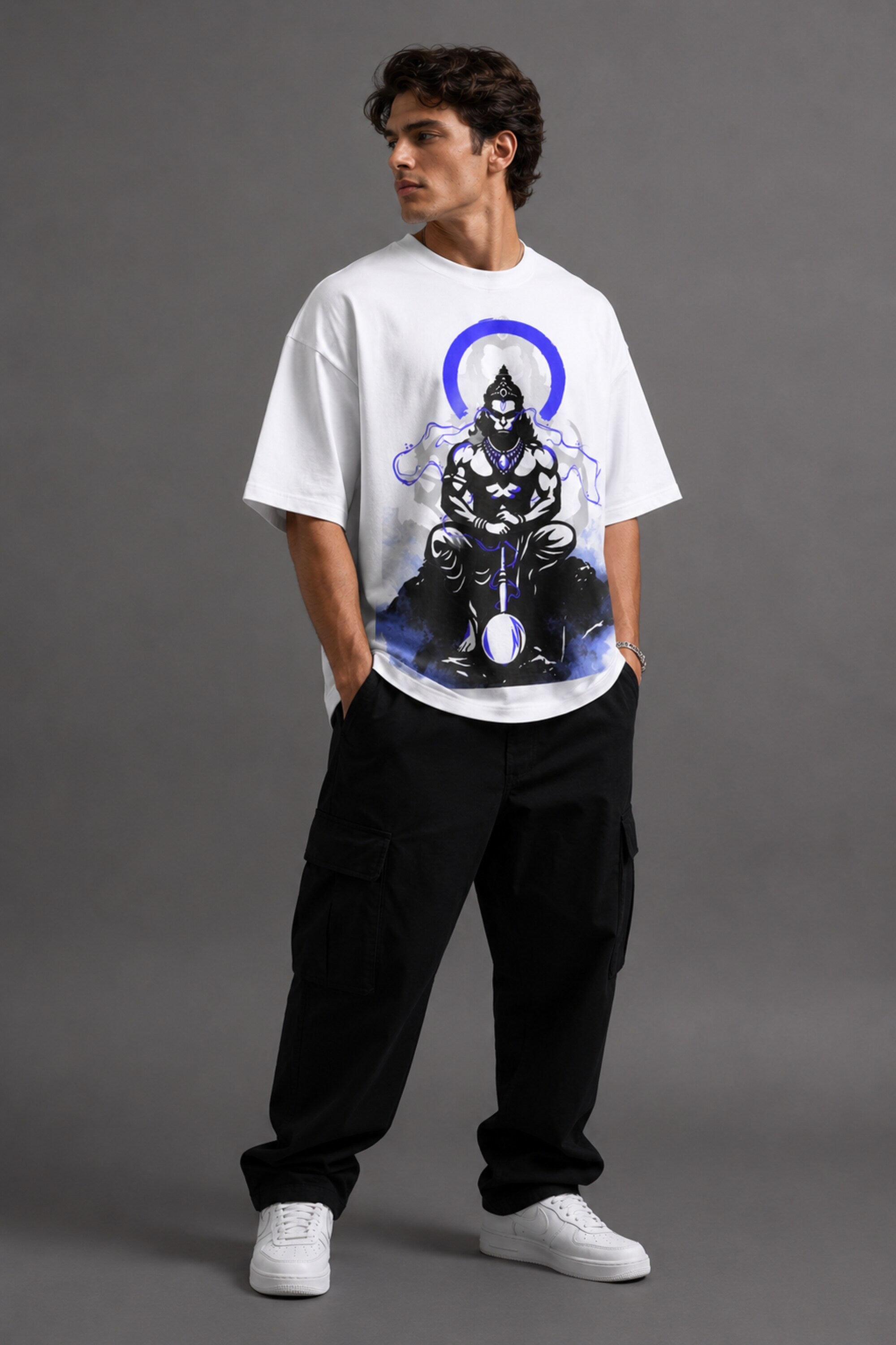 White oversized t-shirt featuring a striking black and blue graphic of Hanuman Dada, with a large blue halo. Designed for a relaxed, streetwear fit.