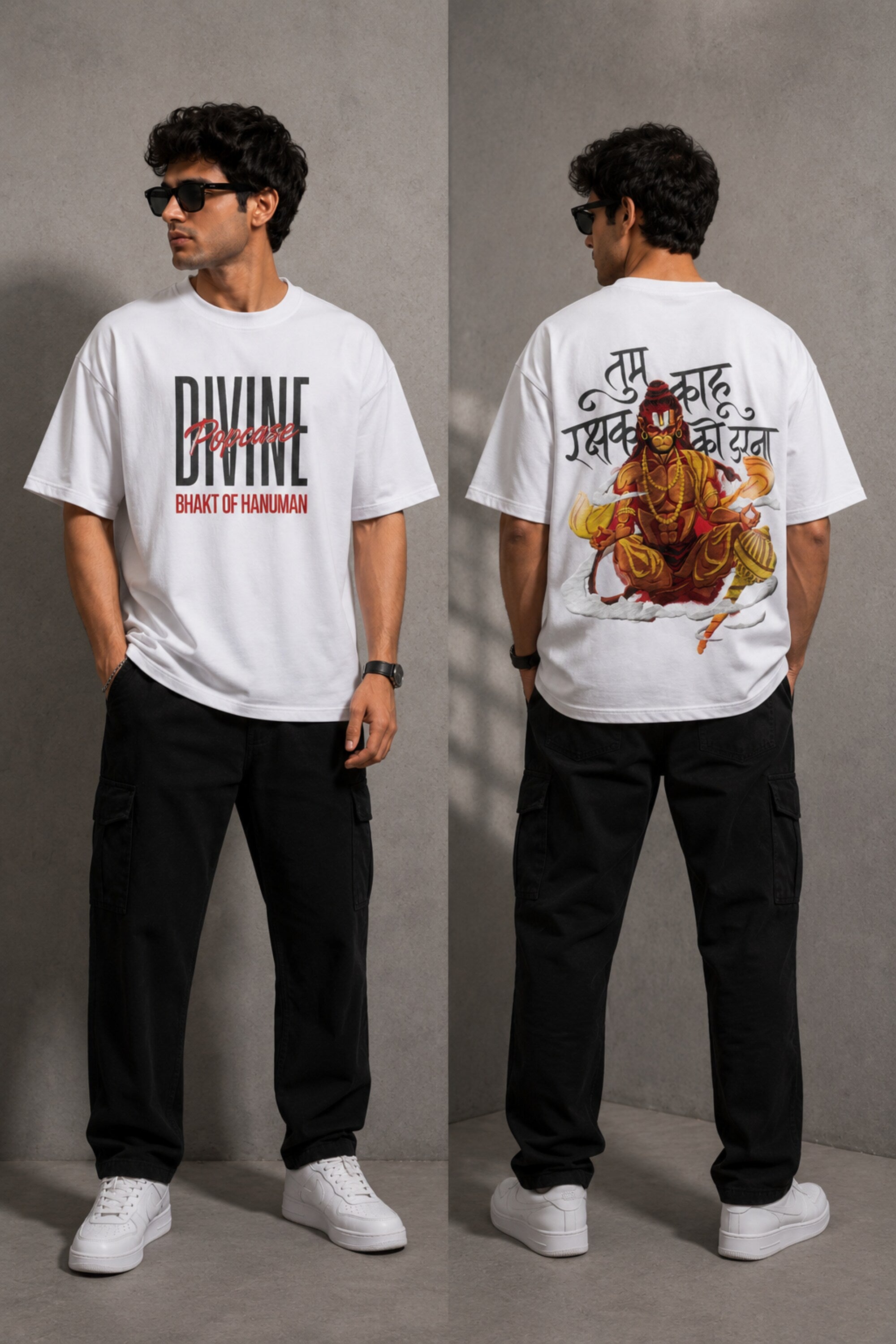 Man wearing a red PROJECTOR HANUMANJI oversized t-shirt with black pants and white sneakers, sitting on metal stairs. - white
