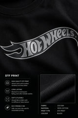 A couple wearing matching black oversized Hot Wheels t-shirts and light wash jeans, posing intimately against a neutral background.