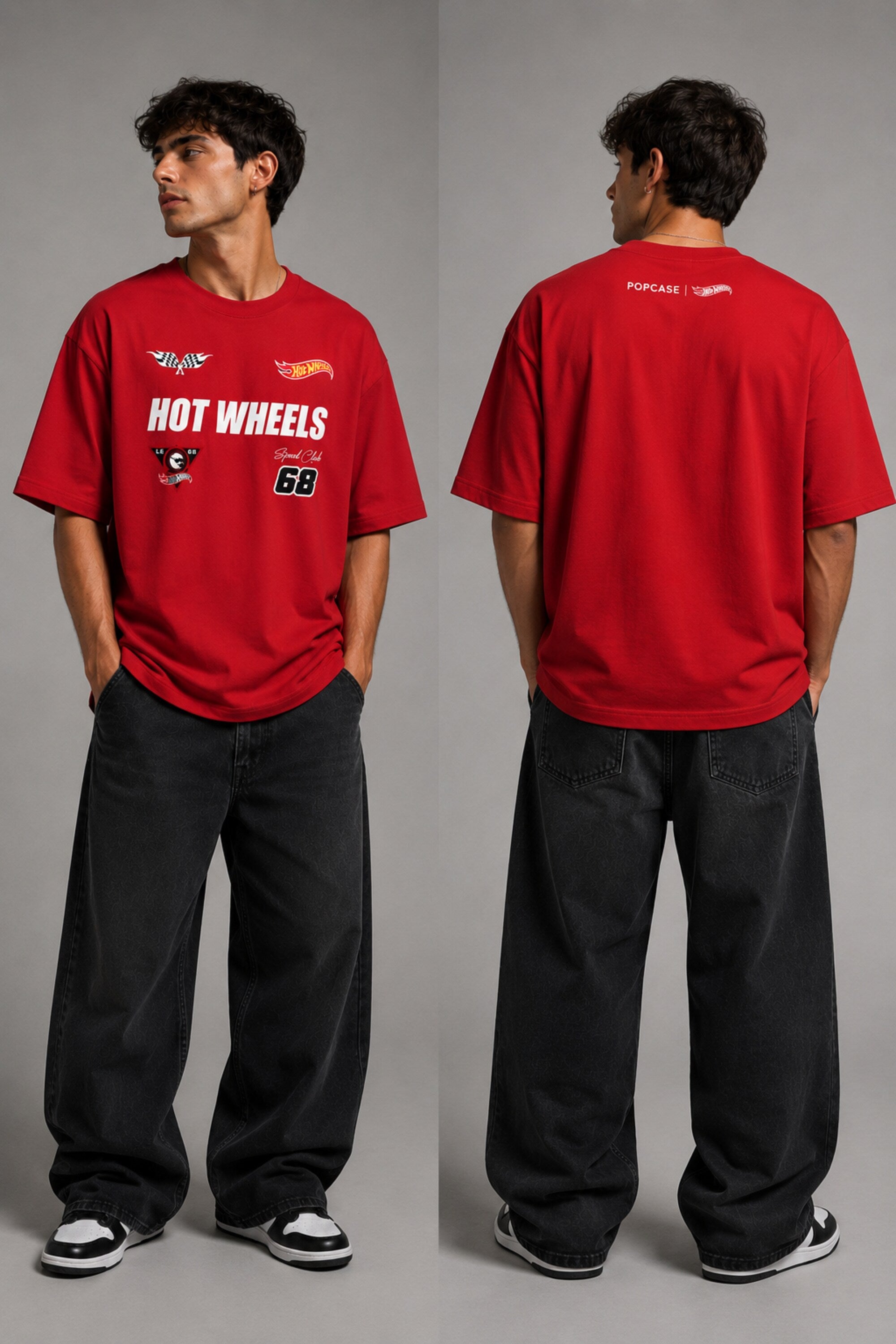 Man wearing a black STAR BOY oversized t-shirt with "Hot Wheels" graphics, sitting on a black couch. Streetwear fashion. - red