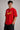 Couple wearing matching red oversized Hot Wheels t-shirts and black bottoms, standing on stairs. Feature iconic Hot Wheels logo.