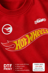 Couple wearing matching red oversized Hot Wheels t-shirts and black bottoms, standing on stairs. Feature iconic Hot Wheels logo.