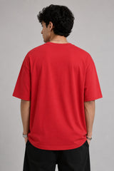 Model wearing a black oversized t-shirt with a vintage Hot Wheels graphic and flames. The tee has a relaxed fit and is paired with black pants.