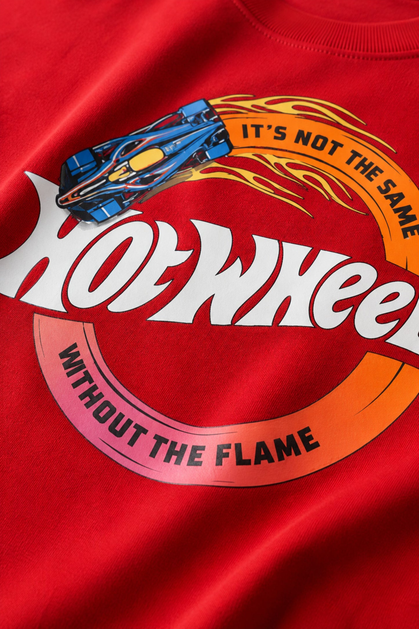 Model wearing a black oversized t-shirt with a vintage Hot Wheels graphic and flames. The tee has a relaxed fit and is paired with black pants.