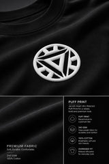 Couple wearing black Iron Man Jarvish oversized t-shirts. Man's back shows "IRON MAN" logo. Woman's front shows Iron Man arc reactor logo. Dark grey background.