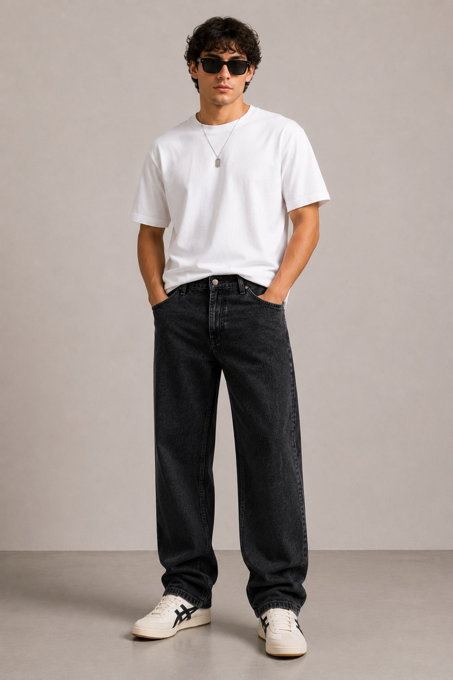 Person wearing a white t-shirt, black jeans, and sunglasses against a plain background